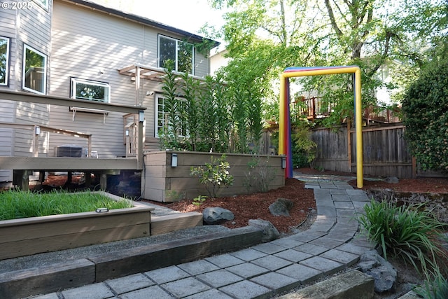 view of yard with fence and central air condition unit