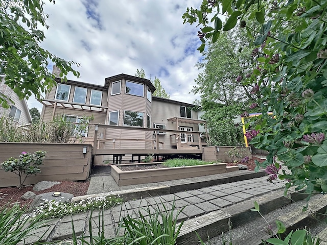 back of property featuring a deck