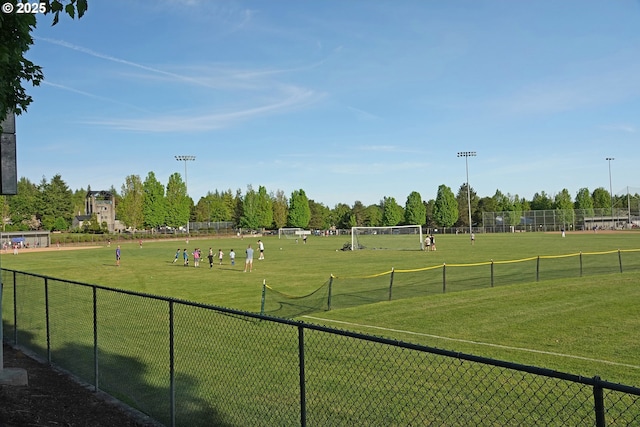 view of home's community with a sport area and fence