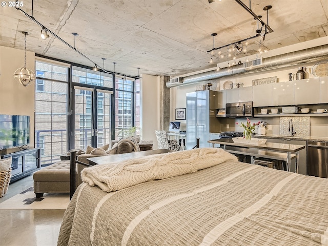 1030 NW 12th Ave Unit 410, Portland, OR 97209 - bedroom with a sink, a wall of windows, and concrete floors