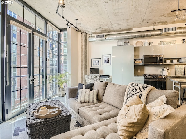 1030 NW 12th Ave Unit 410, Portland, OR 97209 - living area with floor to ceiling windows and visible vents