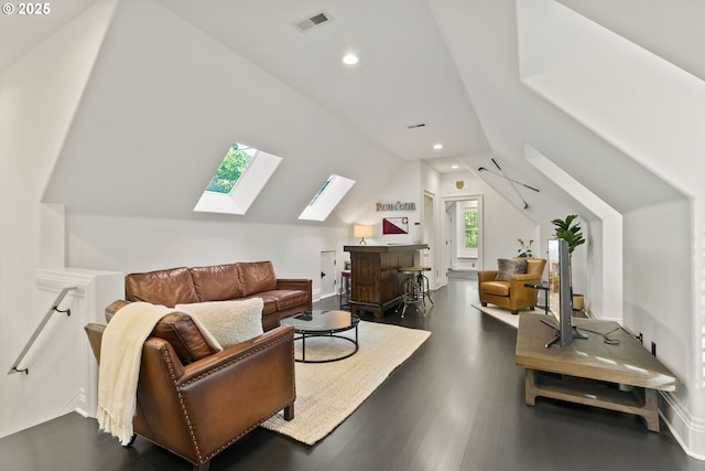 living area with a skylight, vaulted ceiling, recessed lighting, dark wood-style flooring, and baseboards