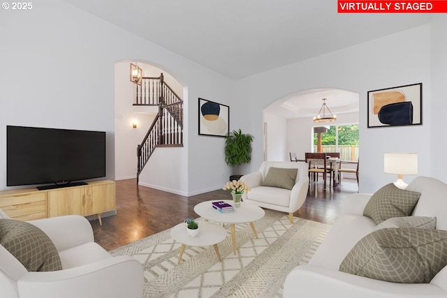 18930 Highland Dr, Oregon City, OR 97045 - living area with arched walkways, a chandelier, wood finished floors, and stairs