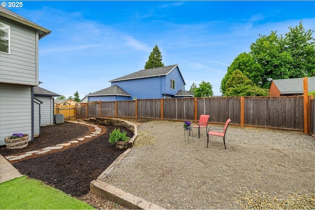 fenced backyard featuring central AC