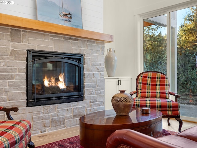 sitting room with hardwood / wood-style flooring and a fireplace