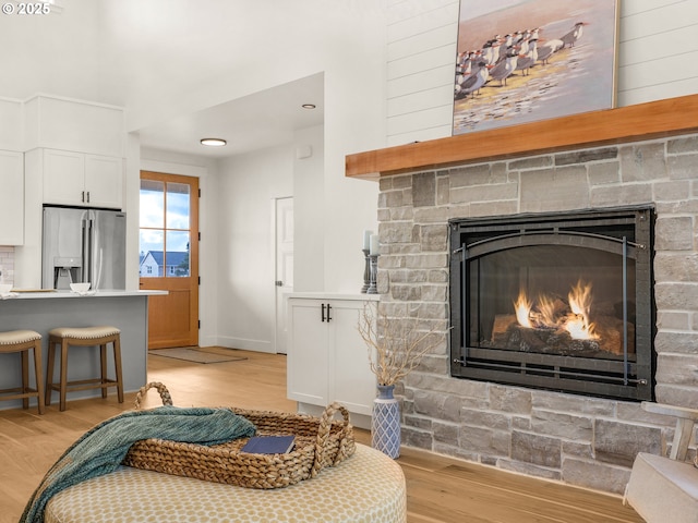 90202 Hobie Rd, Warrenton, OR 97146 - living area with a fireplace, light wood finished floors, and baseboards