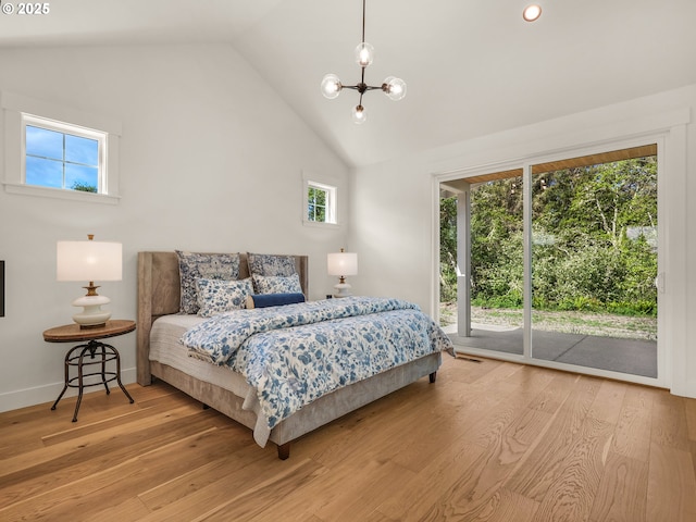 90202 Hobie Rd, Warrenton, OR 97146 - bedroom with access to outside, a chandelier, light wood-style flooring, high vaulted ceiling, and baseboards