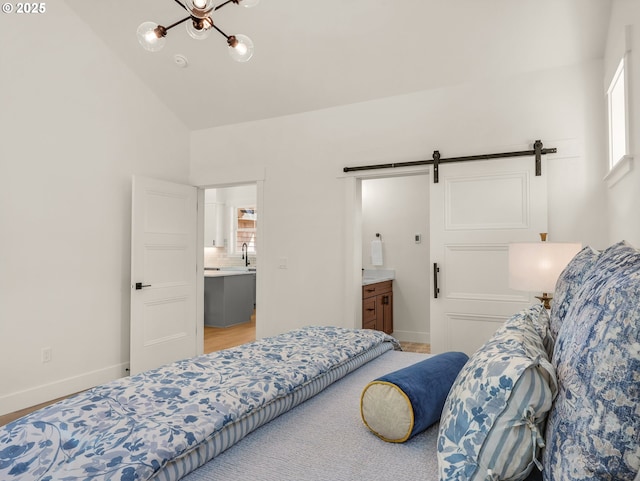 90202 Hobie Rd, Warrenton, OR 97146 - bedroom with a barn door, multiple windows, lofted ceiling, baseboards, and a chandelier