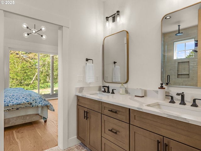 90202 Hobie Rd, Warrenton, OR 97146 - bathroom featuring a shower stall, double vanity, baseboards, and connected bathroom
