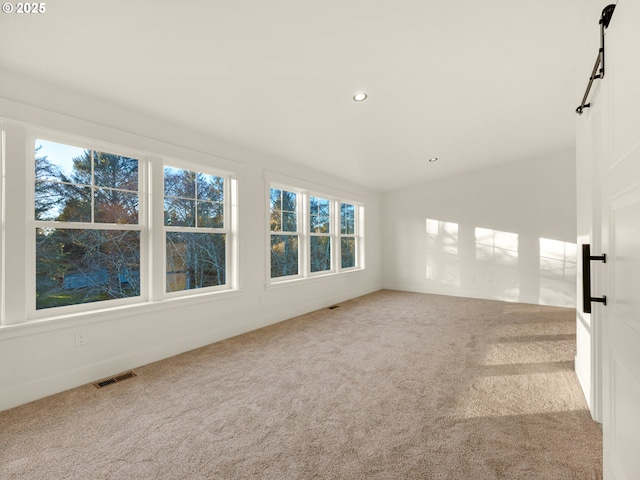 carpeted empty room with lofted ceiling