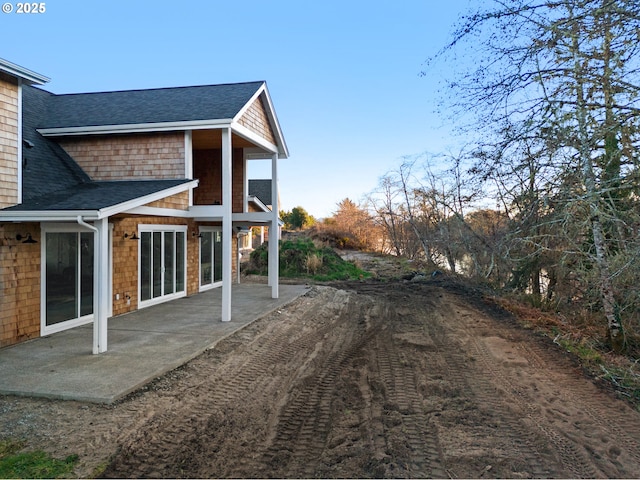 view of side of home featuring a patio area