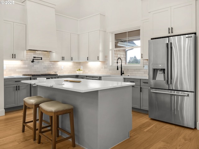 90202 Hobie Rd, Warrenton, OR 97146 - kitchen with appliances with stainless steel finishes, gray cabinetry, and light wood-type flooring