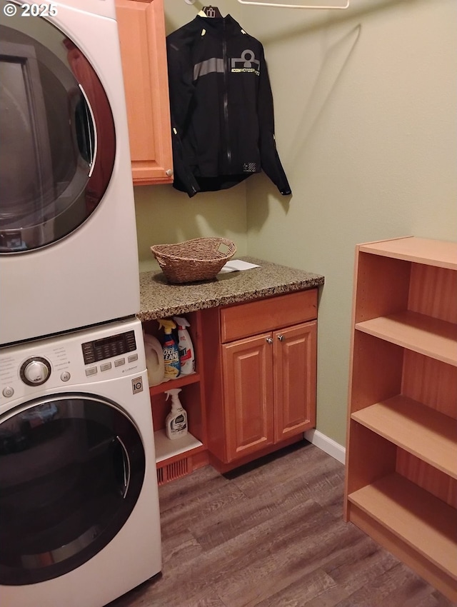 2405 Strasburg Dr, Forest Grove, OR 97116 - laundry area with estacked washer and dryer, cabinet space, and dark wood-style flooring