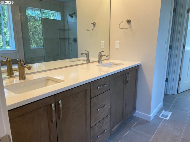 7827 SW Thornbridge Ter Unit 9, Beaverton, OR 97007 - bathroom featuring double vanity, a stall shower, and tile patterned floors