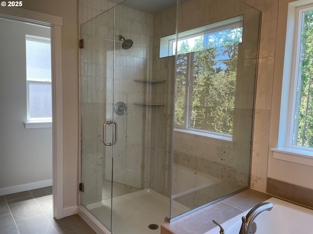7827 SW Thornbridge Ter Unit 9, Beaverton, OR 97007 - bathroom featuring a stall shower, a bath, tile patterned floors, and baseboards
