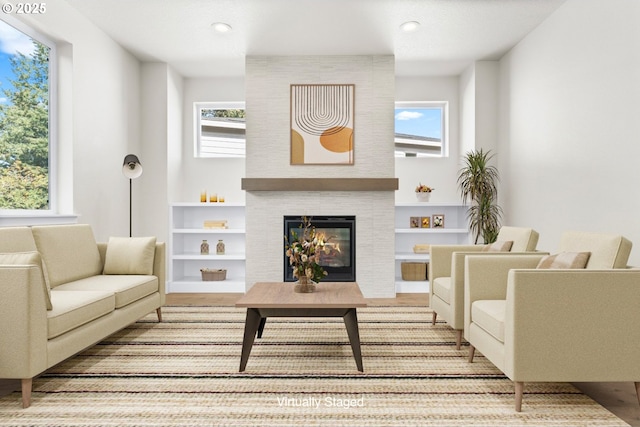 7827 SW Thornbridge Ter Unit 9, Beaverton, OR 97007 - living area featuring a fireplace, healthy amount of natural light, wood finished floors, recessed lighting, and built in shelves
