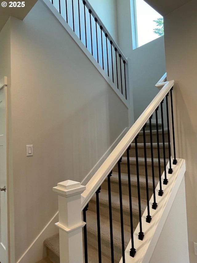 7827 SW Thornbridge Ter Unit 9, Beaverton, OR 97007 - staircase featuring baseboards and a towering ceiling
