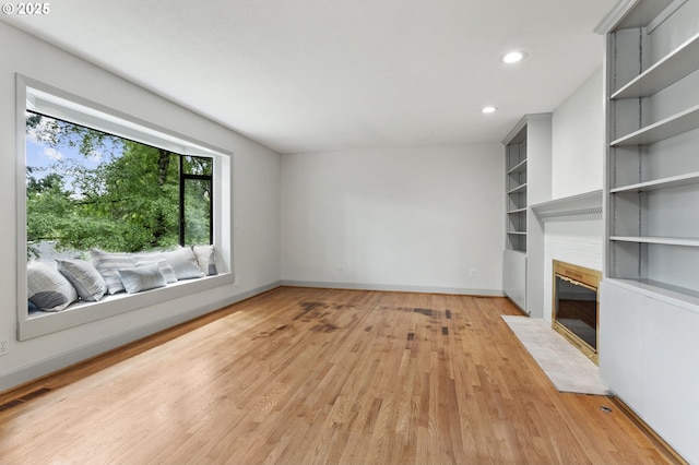 13980 Shireva Ct, Lake Oswego, OR 97034 - unfurnished living room featuring light wood-type flooring, a fireplace with flush hearth, built in features, and recessed lighting
