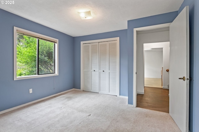 13980 Shireva Ct, Lake Oswego, OR 97034 - unfurnished bedroom with carpet, a closet, and a textured ceiling
