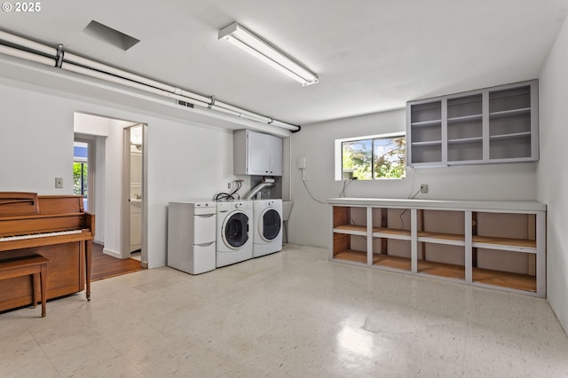 13980 Shireva Ct, Lake Oswego, OR 97034 - laundry area featuring cabinet space, washing machine and clothes dryer, and light flooring