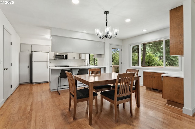 13980 Shireva Ct, Lake Oswego, OR 97034 - dining space with healthy amount of natural light, a chandelier, recessed lighting, and light wood finished floors