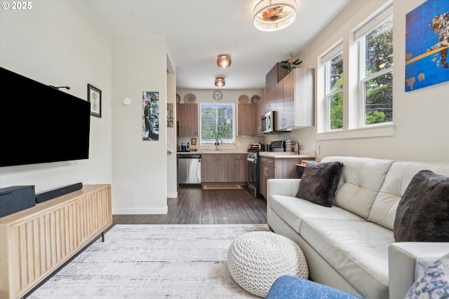 116 NE 109th Ave, Portland, OR 97220 - living area featuring dark wood-type flooring and baseboards