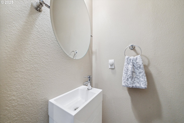 116 NE 109th Ave Unit A5, Portland, OR 97220 - bathroom with vanity and a textured wall