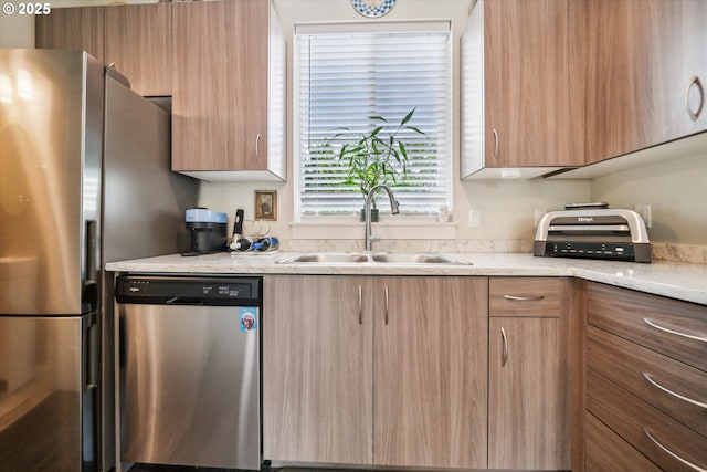 116 NE 109th Ave, Portland, OR 97220 - kitchen featuring stainless steel appliances, a sink, modern cabinets, light brown cabinets, and light stone countertops