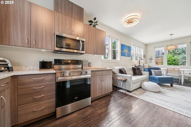 116 NE 109th Ave, Portland, OR 97220 - kitchen featuring appliances with stainless steel finishes, healthy amount of natural light, light countertops, and dark wood finished floors