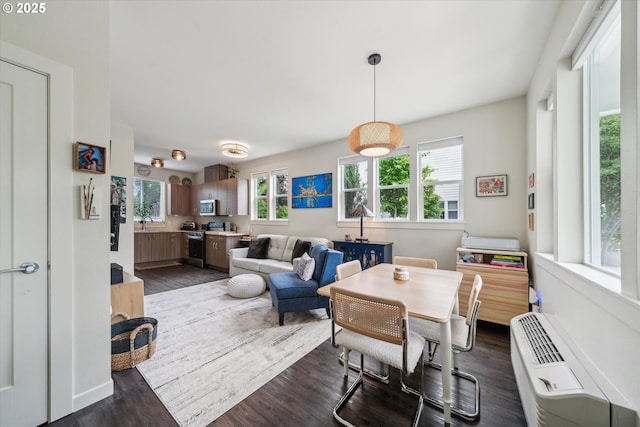 116 NE 109th Ave, Portland, OR 97220 - dining area featuring plenty of natural light, dark wood-style flooring, and an AC wall unit