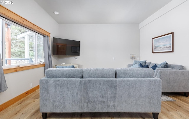 living area featuring light wood finished floors and baseboards