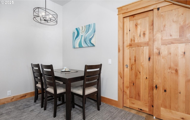 dining area with an inviting chandelier and baseboards