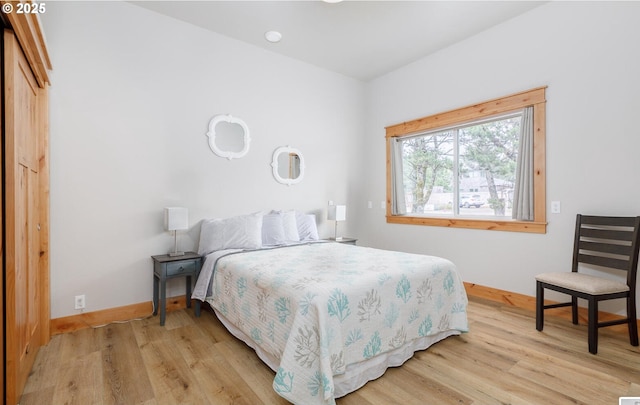 bedroom featuring baseboards and light wood-style floors