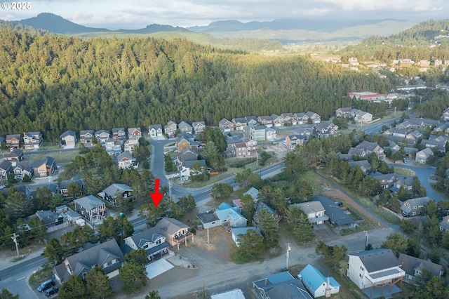 drone / aerial view with a residential view, a mountain view, and a forest view