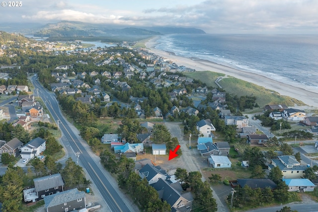 birds eye view of property featuring a water view and a view of the beach