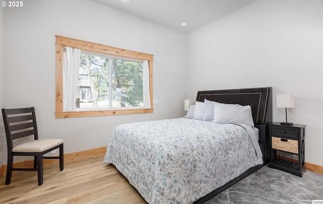 bedroom with recessed lighting, wood finished floors, and baseboards