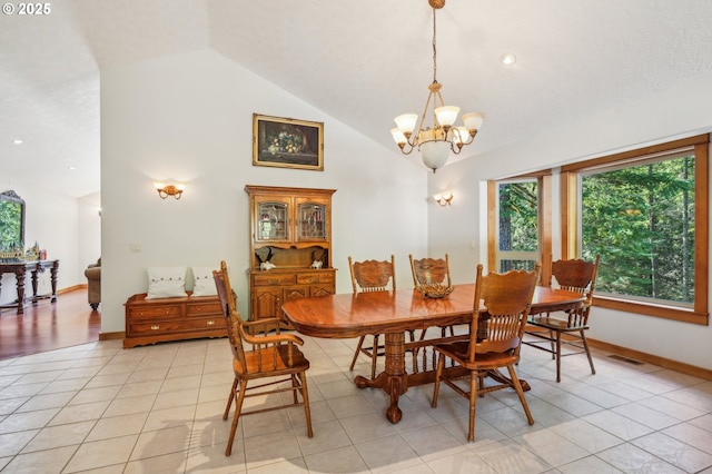 dining space featuring light tile patterned floors, baseboards, visible vents, high vaulted ceiling, and a notable chandelier