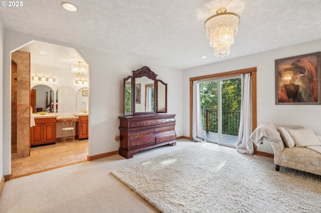 bedroom with a chandelier, light colored carpet, access to exterior, ensuite bath, and recessed lighting
