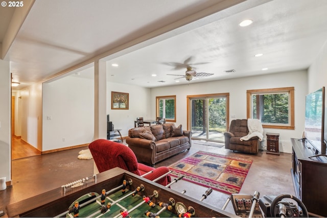living room featuring concrete flooring, recessed lighting, ceiling fan, and baseboards