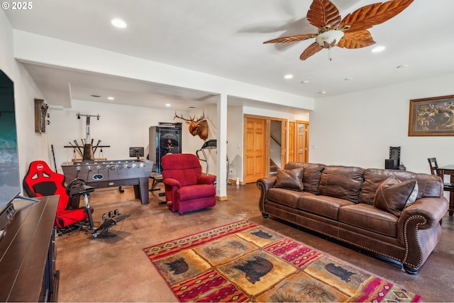 living area with recessed lighting, a ceiling fan, stairs, and concrete flooring