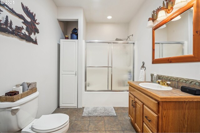 full bath with toilet, recessed lighting, vanity, combined bath / shower with glass door, and tasteful backsplash