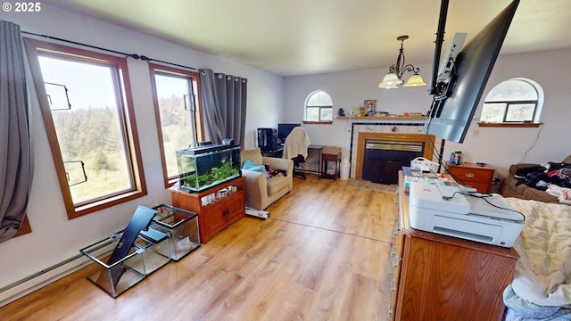 living room with light wood-style floors and a fireplace