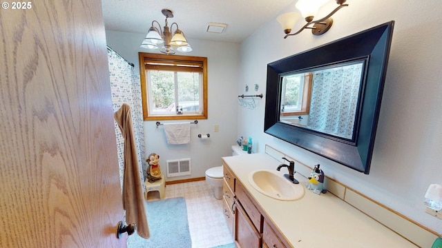 full bathroom with visible vents, vanity, tile patterned floors, toilet, and a notable chandelier