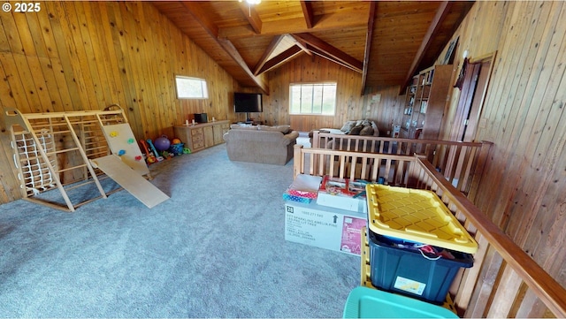 playroom with carpet flooring, wood ceiling, lofted ceiling with beams, and wood walls