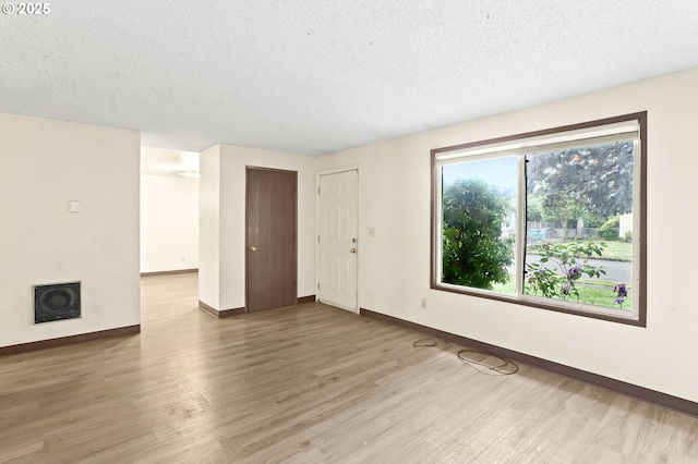 9208 NE 27th St, Vancouver, WA 98662 - unfurnished living room with baseboards, a textured ceiling, and wood finished floors