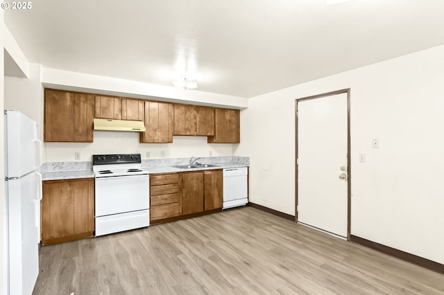 9208 NE 27th St, Vancouver, WA 98662 - kitchen featuring white appliances, under cabinet range hood, brown cabinets, a sink, and light wood-style floors