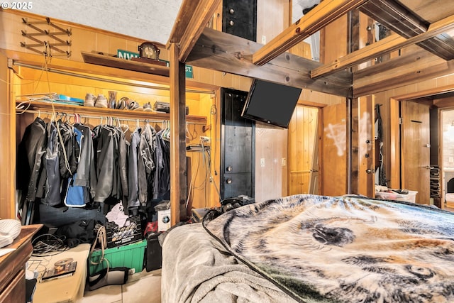 bedroom featuring wooden walls