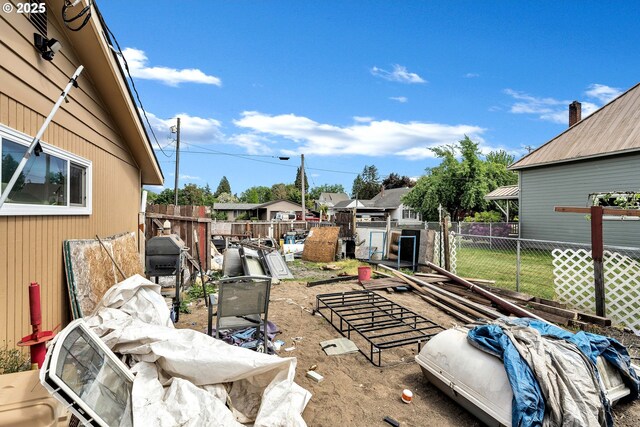 fenced backyard featuring a residential view