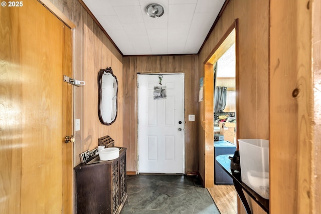 foyer featuring wood walls
