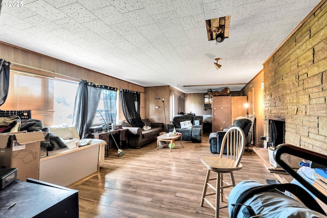 living area featuring wood finished floors and wooden walls